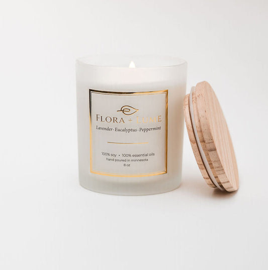 Candle with a wooden lid on a white background