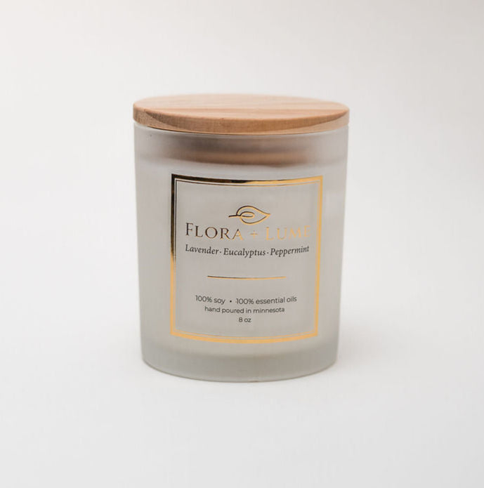 Candle with a wooden lid on a white background